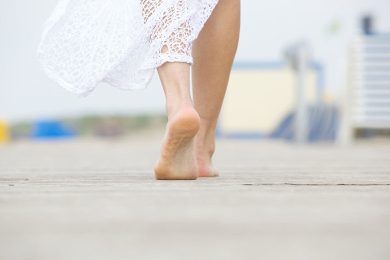 28108001 - close up low angle barefoot woman walking away